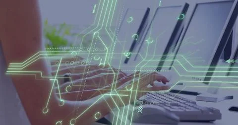 Typing office professional using keyboard at desk with three monitors, circuit Stock Photos