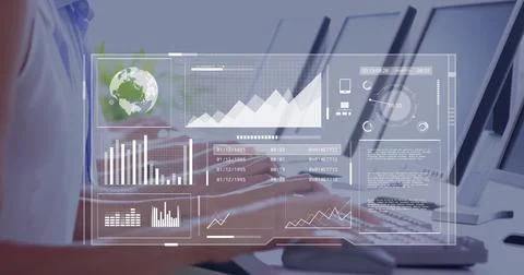 Typing office worker analyzing holographic data on computer monitors at desk Stock Photos