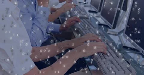 Typing office workers entering program commands at long office desk, with 스톡 사진