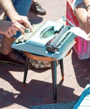 Typing on old light blue typewriter Stock Photos