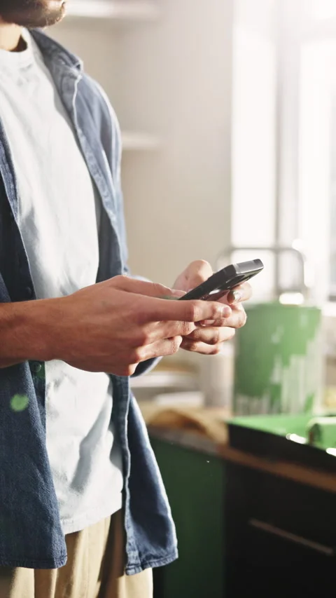 Typing, painter and hands with phone in kitchen, home renovation tutorial and Vídeos de archivo 331504296