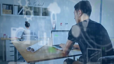 Typing pair in dark shirt and striped top at office table with laptop, plans, Stock Footage 331615343