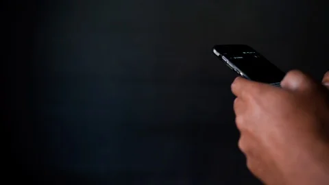 Typing on phone side angle close up at home while bored Stock Footage 127975352