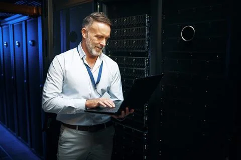 Typing, programmer and man in server room, laptop and cyber security with 写真素材