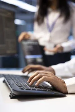 Typing, programming and keyboard in closeup at data center Stockfoto's