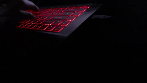Typing on a red-glowing keyboard 库存影片 201817250