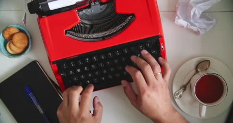 Typing on red typewriter with tea Stock Footage 317166842