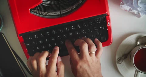 Typing on red typewriter with tea Stock Footage 317166849