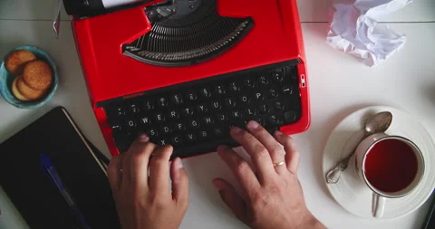 Typing on red typewriter with tea Stock Footage 317166860