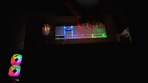 Typing on RGB Backlit Keyboard in Dark Room Stock Footage 315982483