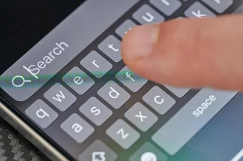 Typing search in iphone app Stock Photos