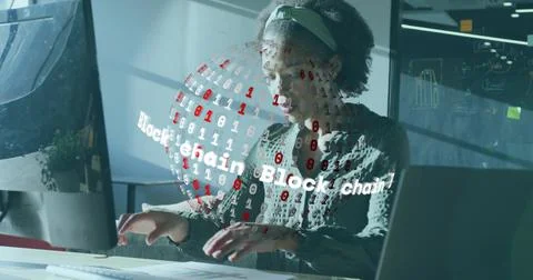 Typing software engineer at modern office desk with holographic blockchain Stockfoto's