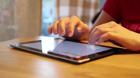 Typing on tablet in a cafe Stock Footage 53229608