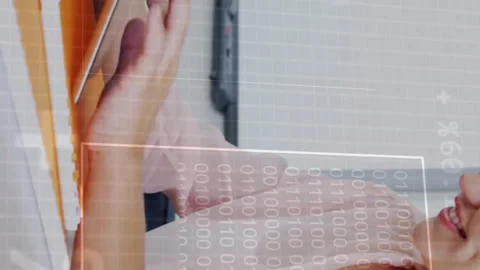 Typing on tablet, person with binary code animation overlay in school setting Stock Footage 313339642