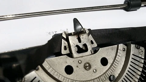 Typing text "dear dad" on white paper Stock Footage 74861300