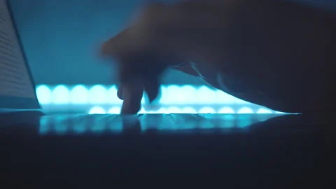Typing text on laptop keyboard. Work on laptop at night, blue light. Macro. Stock Footage 151619230