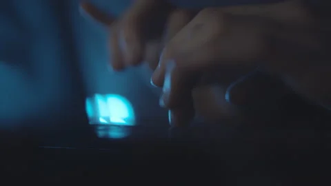 Typing text on laptop keyboard. Work on laptop at night, blue light. Macro. Stock Footage 151620071