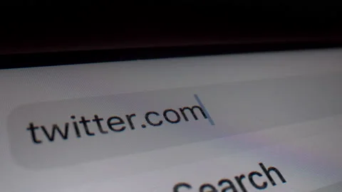 Typing Twitter domain in browser bar - Macro Stock Footage 145645141