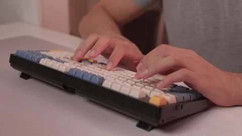 Typing in warm ambient light. Steady rhythm while coding with colorful keycaps Stock-Footage 347873638