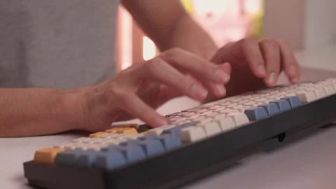 Typing in warm ambient light. Steady rhythm while coding with colorful keycaps Stock-Footage 347873653