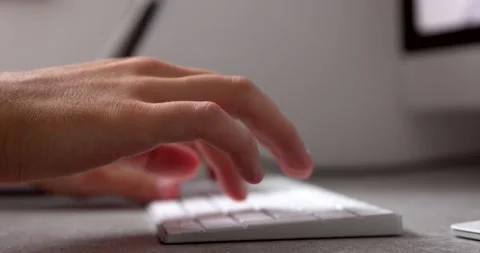 Typing on a white computer wireless keyboard by male hands while working and Stock Footage 150206743