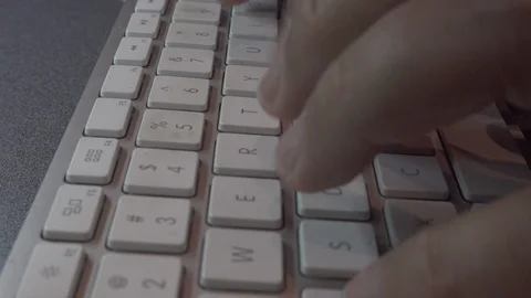 Typing on a white keyboard￼ on gray table￼￼. Stock Footage 119262197