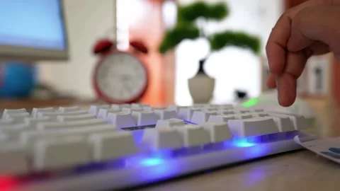 Typing on White Mechanical Keyboard with Blue Backlighting Stock Footage 316902025