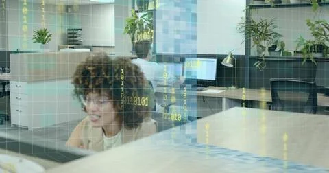 Typing woman in blazer using computer and keyboard at office desk, with plants, Stockfoto's