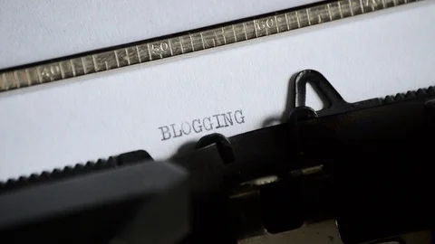 Typing the word BLOGGING with an old manual typewriter Stock Footage 72659989