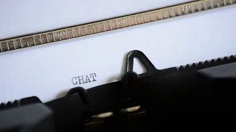 Typing the word CHAT with an old manual typewriter Stock Footage 72661315