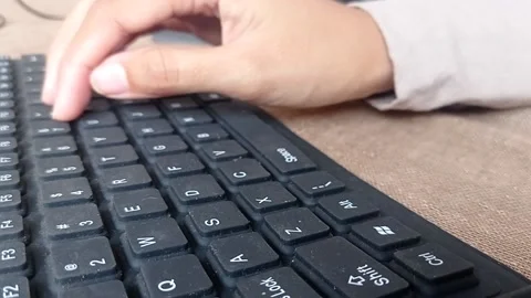 Typing a word on a keyboard Stock Footage 146246831