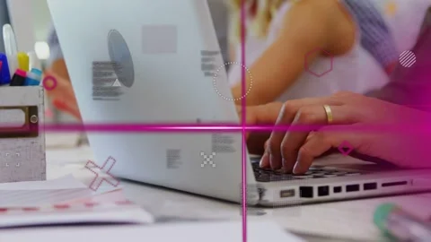 Typist placing hands on laptop, camera panning, magenta grid tracking as hands Stock Footage 334703743