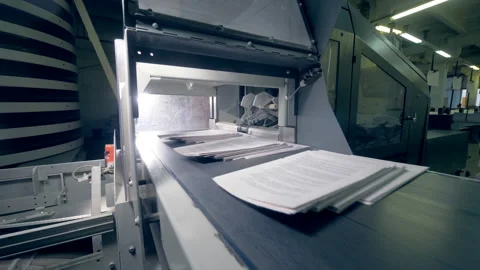 Typographical conveyor moves stacks of paper, close up. Stock Footage 104224529