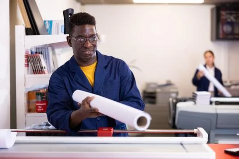 Typography technician offering plotter paper roll Stock Photos