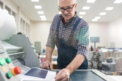 Typography worker examining paper Stock Photos