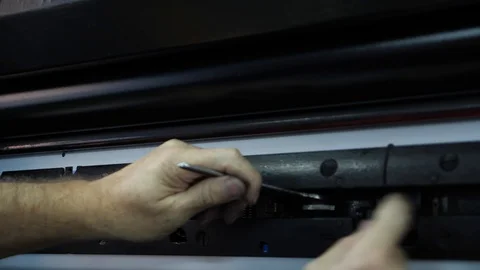 A typography worker inserts a form into a printing press with a tool. 스톡 동영상 98120863