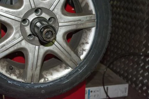 Tyre on the balancing machine prepared for balancing at the tyre shop Stock Photos