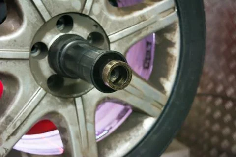 Tyre on the balancing machine prepared for balancing at the tyre shop Stock Photos