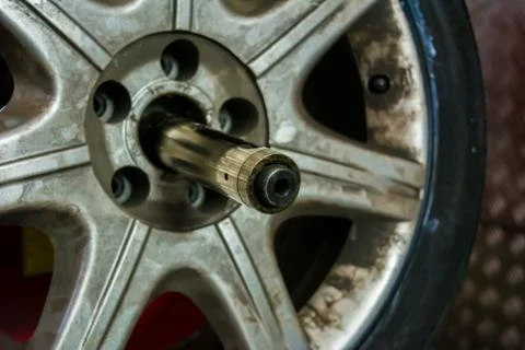 Tyre on the balancing machine prepared for balancing at the tyre shop Stock Photos