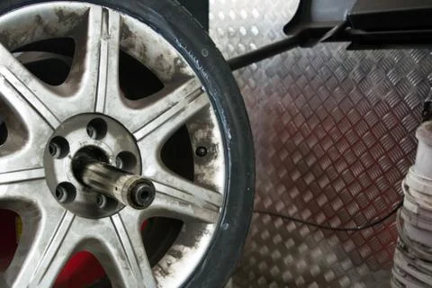 Tyre on the balancing machine prepared for balancing at the tyre shop Stock Photos