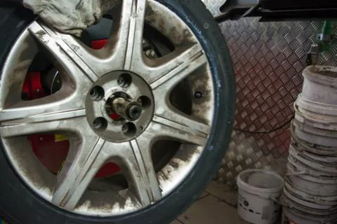 Tyre on the balancing machine prepared for balancing at the tyre shop Фото