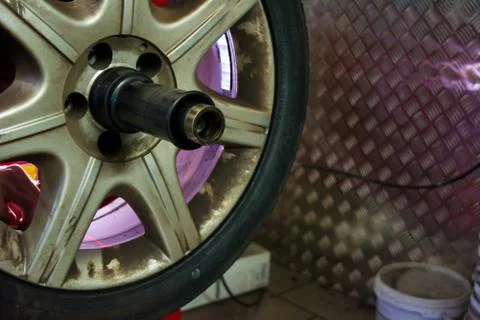 Tyre on the balancing machine prepared for balancing at the tyre shop Фото