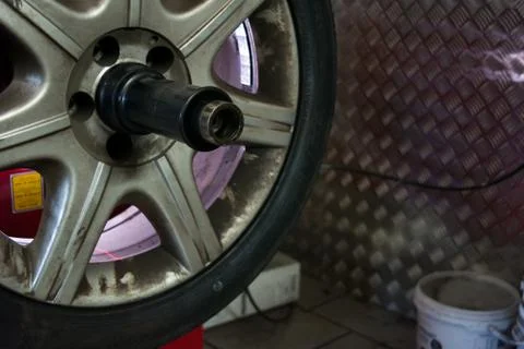 Tyre on the balancing machine prepared for balancing at the tyre shop 스톡 사진
