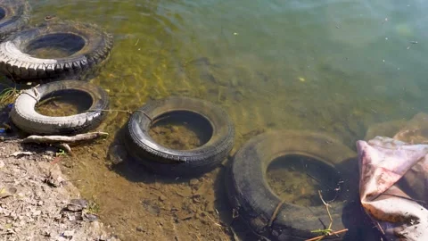Tyre Fallen into the River from Mountain Road Stock Footage 337626879
