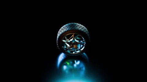 Tyre lit by rotating highlights in a dark studio, seamless looping motion Stock Footage 320655795