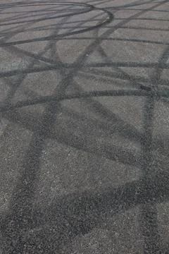 Tyre marks on gray asphalt surface. Stock Photos