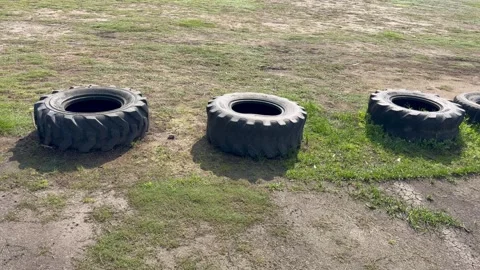 Tyres in a row at a field. Tyres are used to stop cars or create a barrier. Stock Footage 342301324