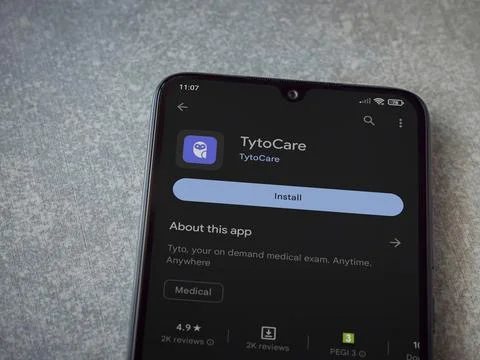 TytoCare app play store page on smartphone on ceramic stone background Stock Photos