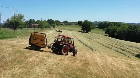 U-turn of a tractor making a round baller Video stock 144484105