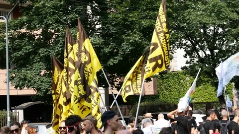 UAAR atheist group flags wave at Milano pride parade. Video stock 79637523